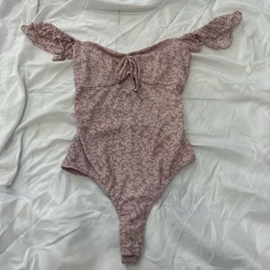 Soft pink body suit.